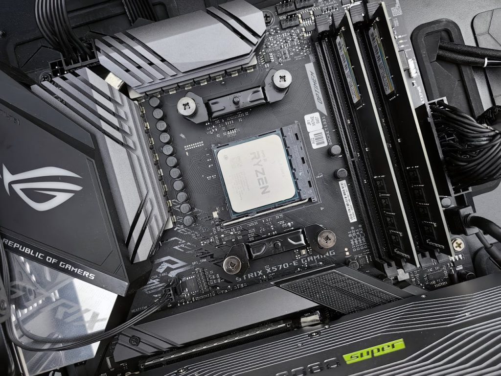 The Art of Drawing Readers In: Your attractive post title goes here Detailed view of a gaming motherboard, showcasing an AMD processor and components.