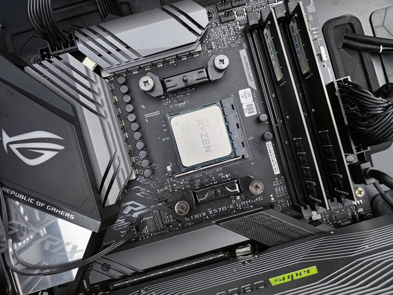Detailed view of a gaming motherboard, showcasing an AMD processor and components.